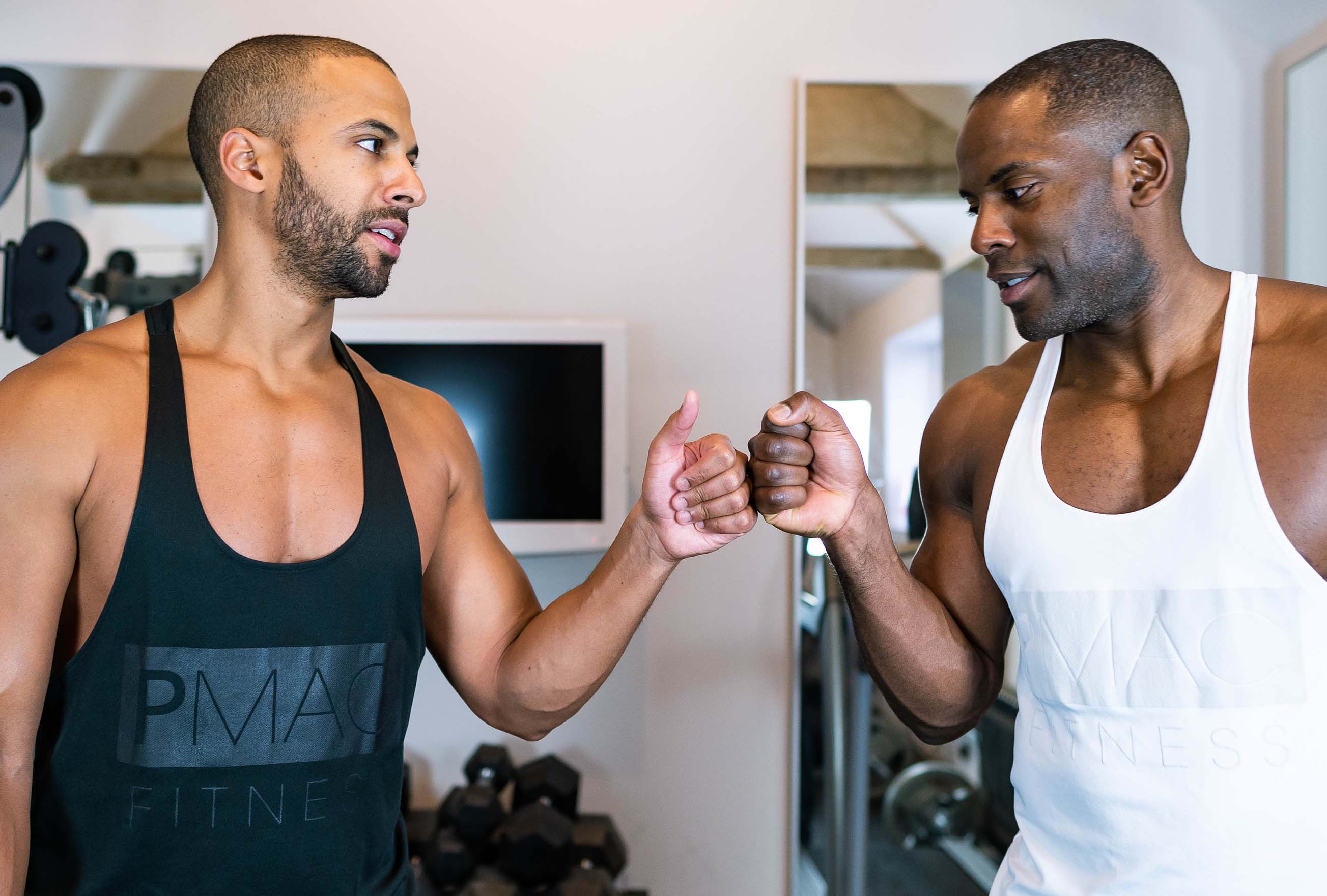 Pete and a client fistbumping and looking at each other.