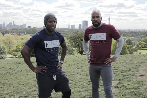 Peter Mac with DJ Spoony on Primrose Hill, with the London skyline behind