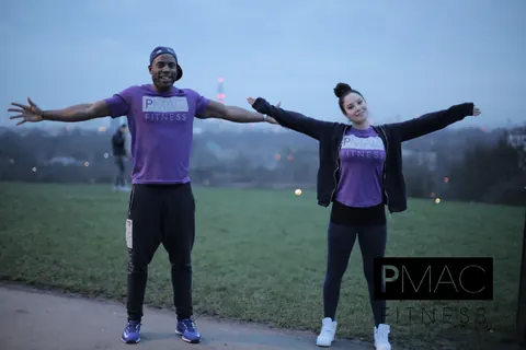 Peter Mac with Tulisa on Primrose Hill at dusk, both with arms outstretched