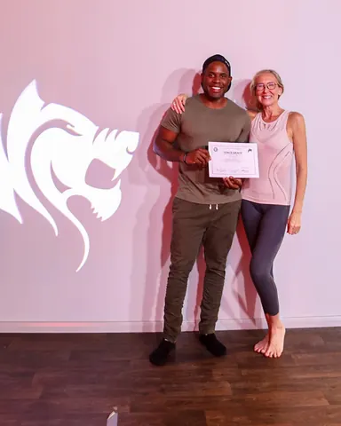 Peter Mac holding his yoga teacher certificate with Fierce Grace founder Michelle Bonetta